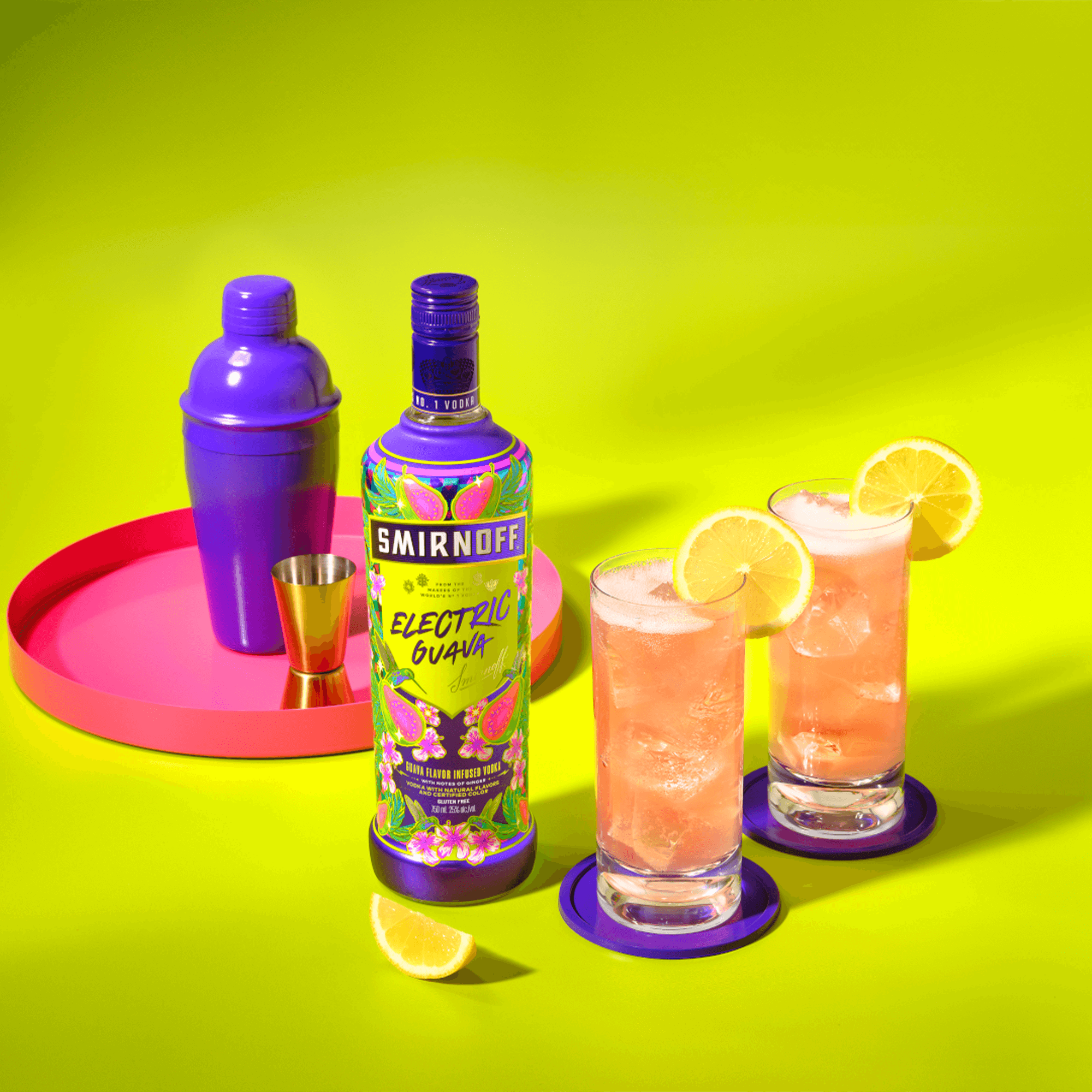 Smirnoff Electric Guava Vodka bottle with cocktails and shaker on vibrant background, showcasing juicy guava flavor.