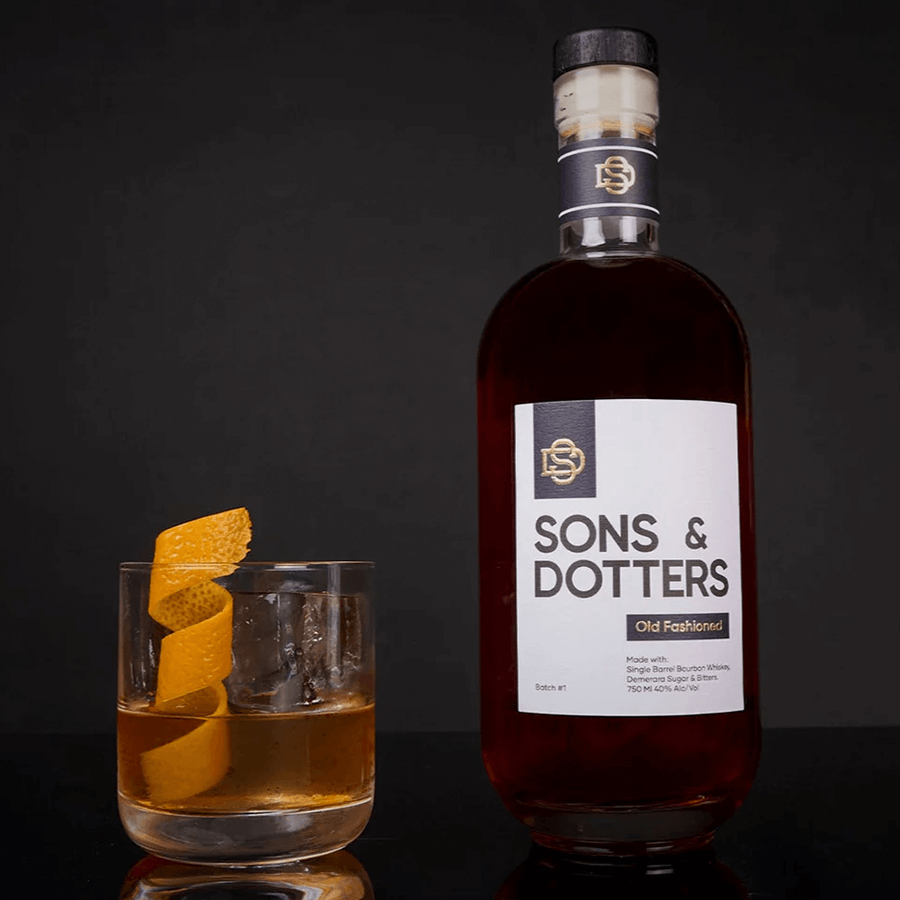 Sons & Dotters Old Fashioned cocktail in a glass with an orange twist, showcasing craftsmanship and convenience.