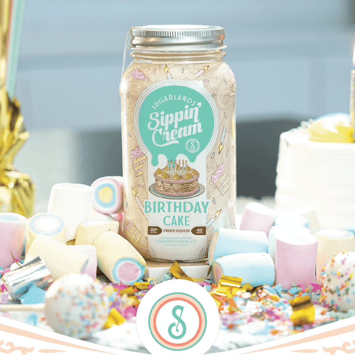 Sugarlands Shine Birthday Cake Sippin' Cream bottle surrounded by colorful party decorations and cake-inspired treats.