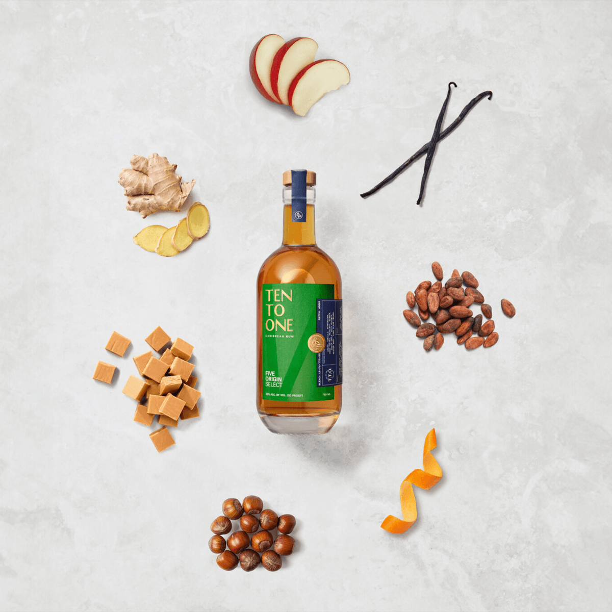 Ten To One Five Origin Select Rum surrounded by ginger, vanilla, cocoa, caramel, apple, and orange peel.