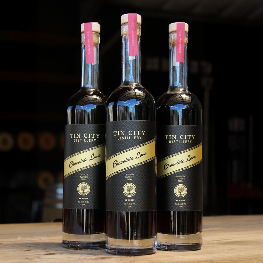 Three bottles of Tin City Vodka Chocolate Love showcasing its rich flavor and smooth spirit.