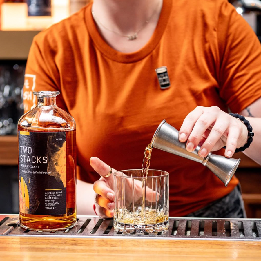 Bartender pouring Two Stacks Brandy whiskey into a glass at a bar.