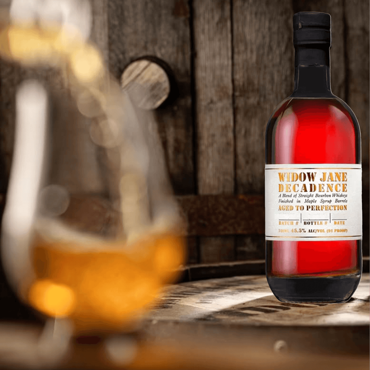 Widow Jane Decadence 2024 Straight Bourbon bottle with amber whiskey in the background, showcasing its rich color and artisanal quality.