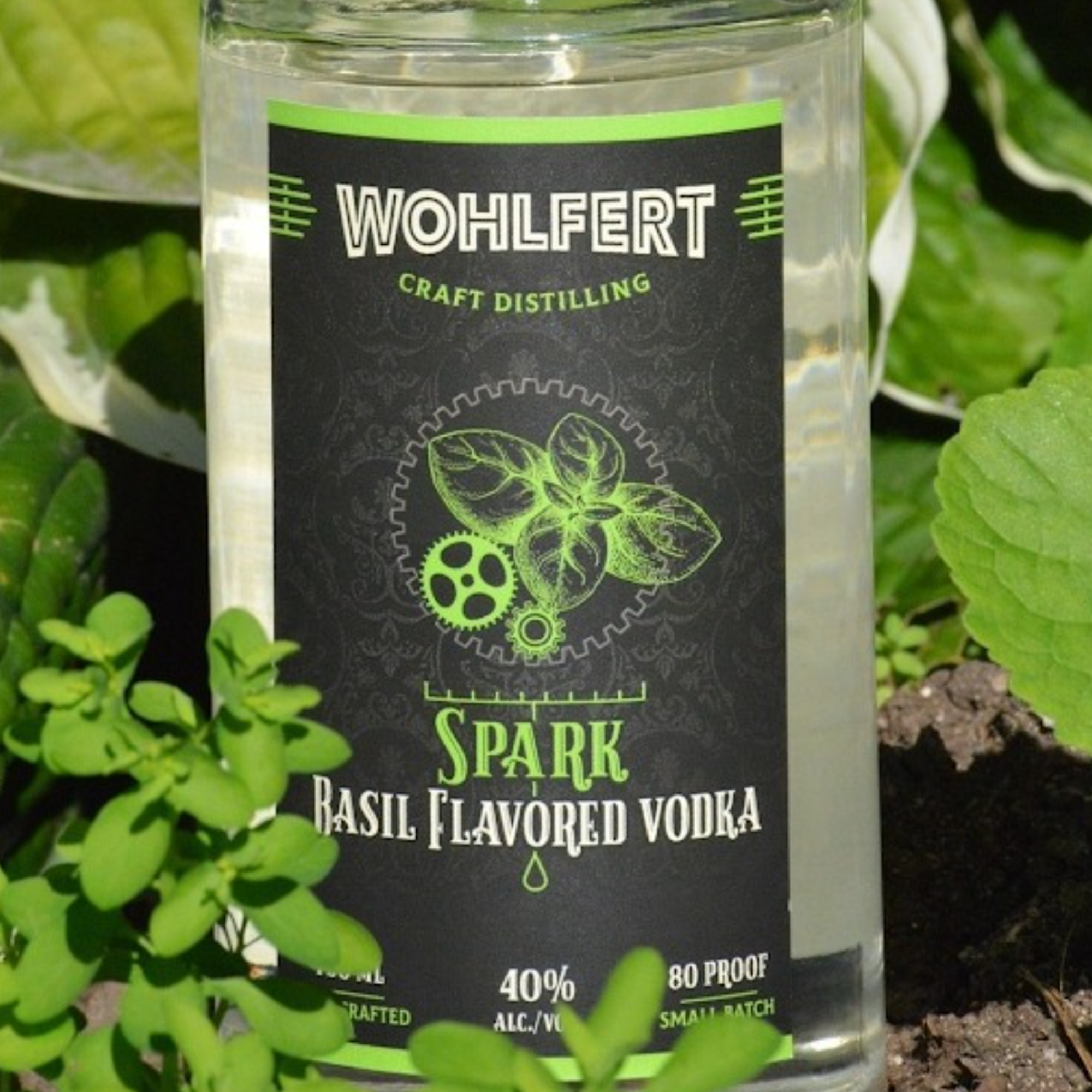 Wohlfert Spark Basil Flavored Vodka bottle featuring fresh basil leaves, showcasing craft distilling quality.