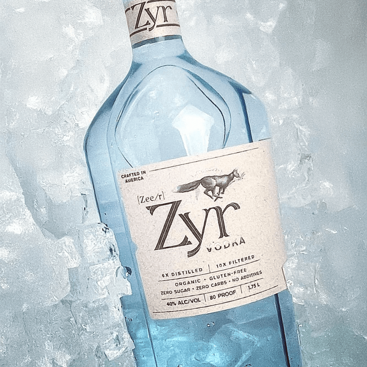 Zyr Organic Vodka 1.75L bottle surrounded by ice, featuring its gluten-free and smooth qualities.