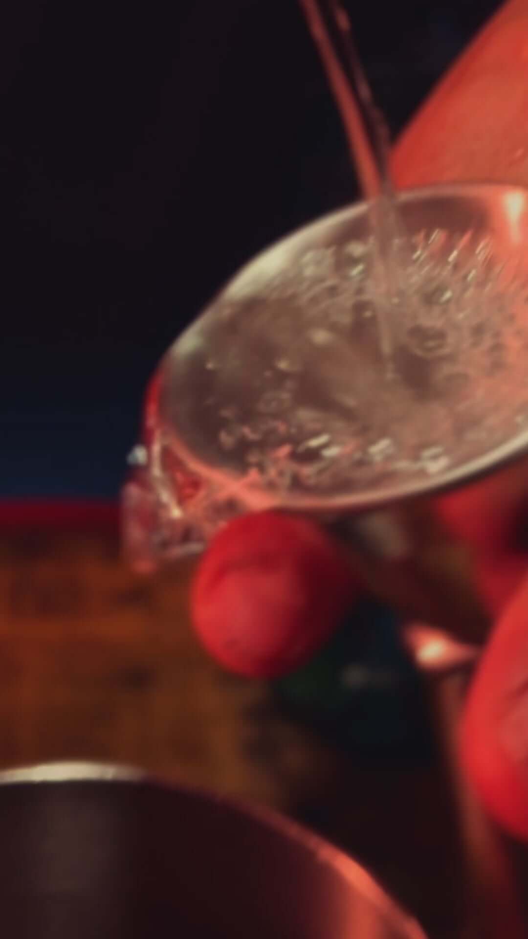 Pouring Mezcal Sin Pena into a glass; showcasing its artisanal and pure qualities.