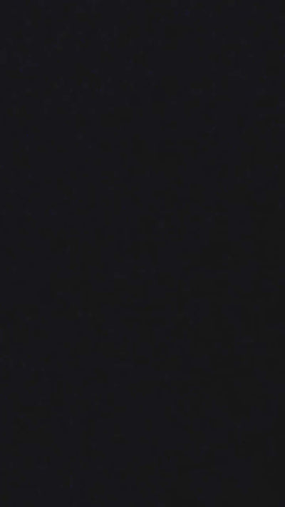 Solid black background with subtle texture, ideal for design and artistic backgrounds.