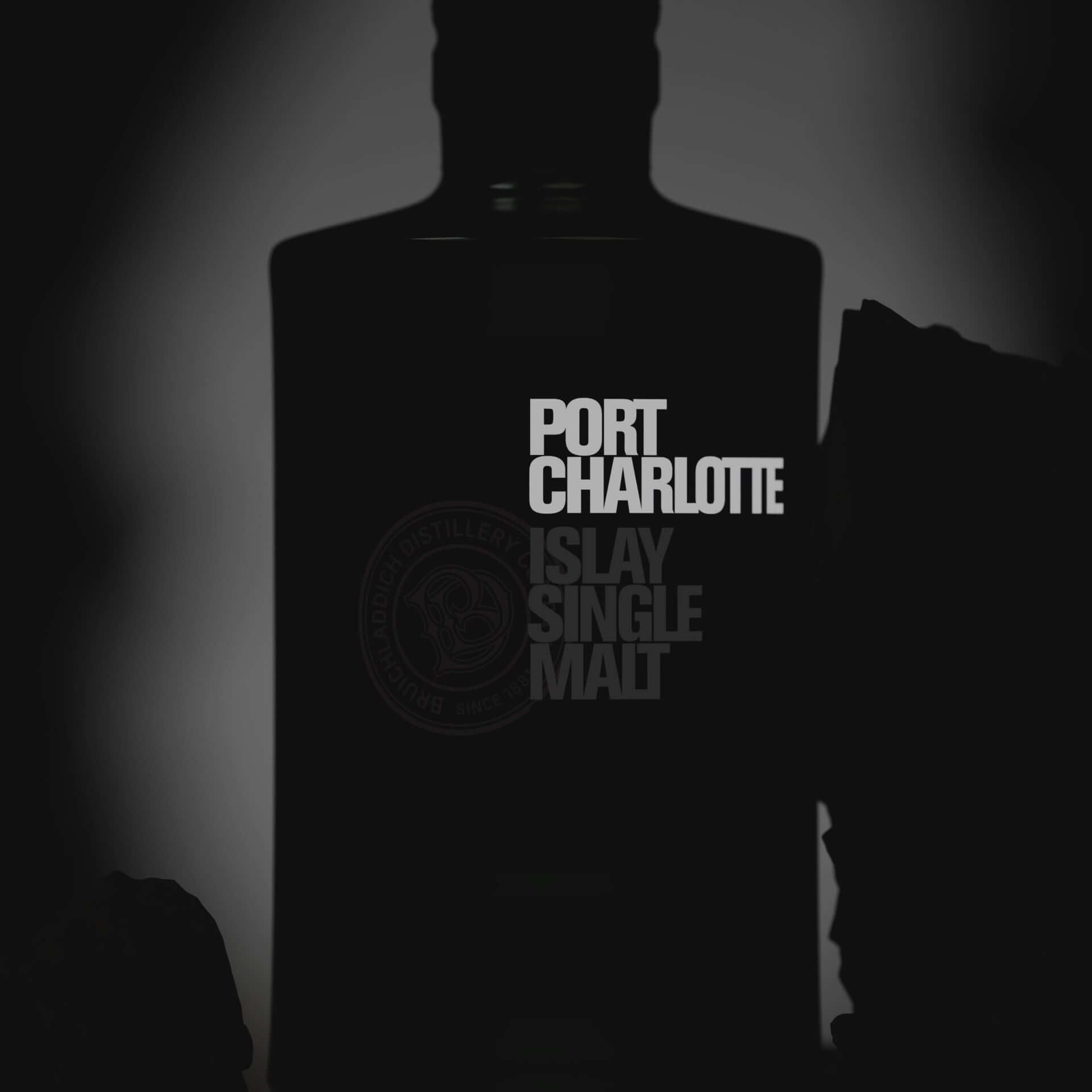 Port Charlotte Islay Single Malt Scotch Whisky bottle silhouette in dark setting.