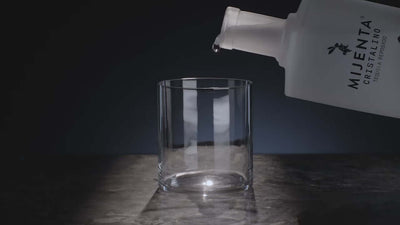 Mijenta Cristalino Tequila pouring into a clear glass, showcasing elegance and sophistication.