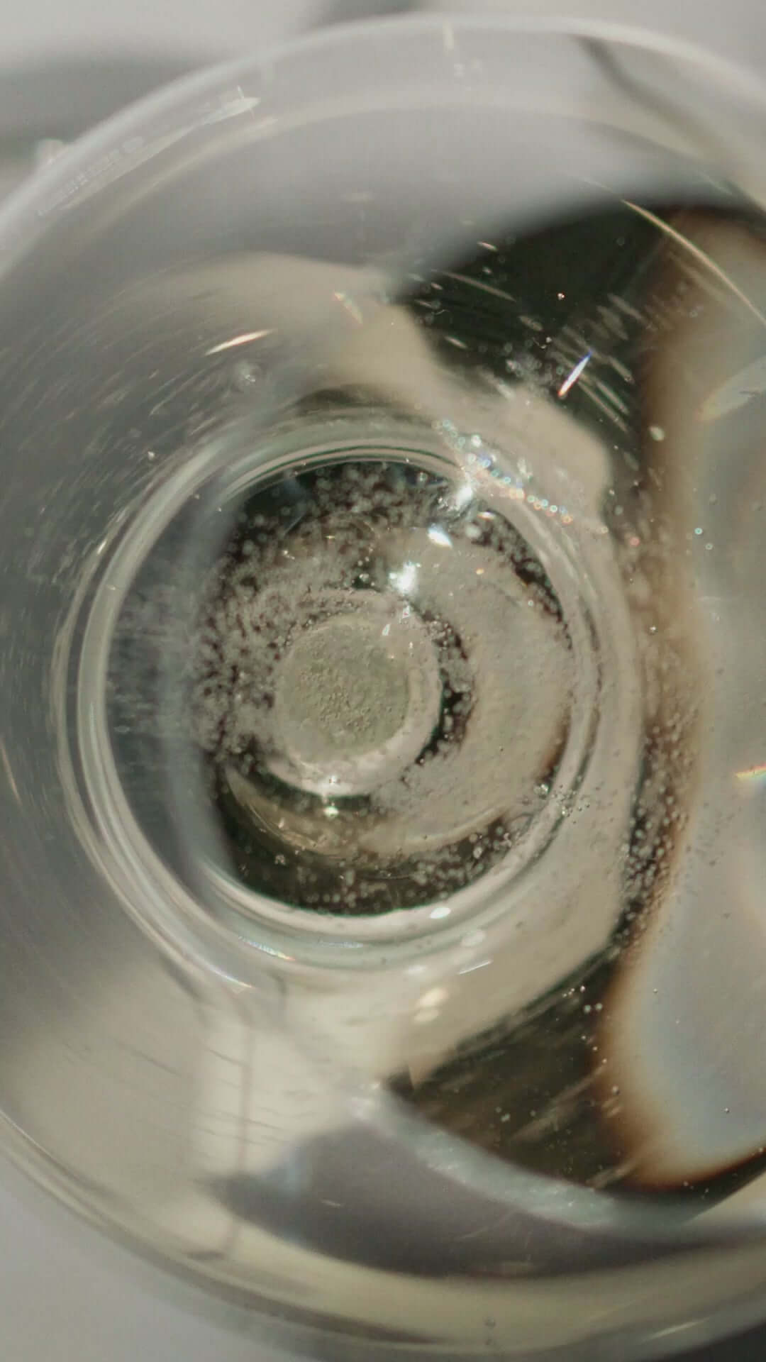 Close-up view of Dom Pérignon 2013 Brut Champagne in a glass, showcasing fine bubbles and clarity.